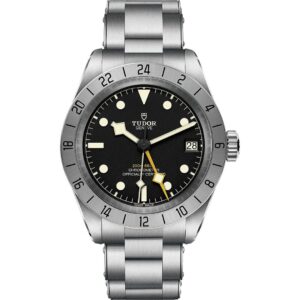 A front view of the Tudor Black Bay Pro watch on a stainless steel bracelet. It features a black dial with luminescent markers, a prominent yellow 24-hour hand, and a fixed stainless steel bezel with a 24-hour scale.