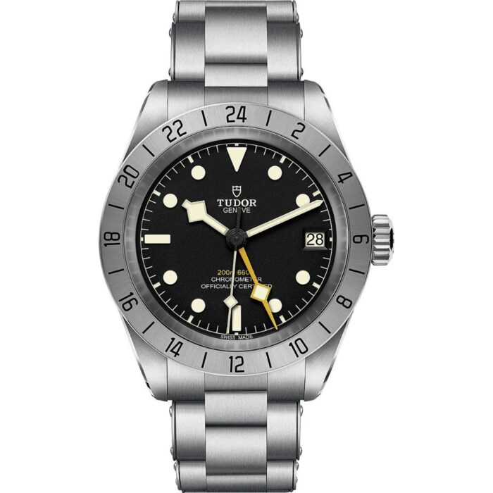A front view of the Tudor Black Bay Pro watch on a stainless steel bracelet. It features a black dial with luminescent markers, a prominent yellow 24-hour hand, and a fixed stainless steel bezel with a 24-hour scale.